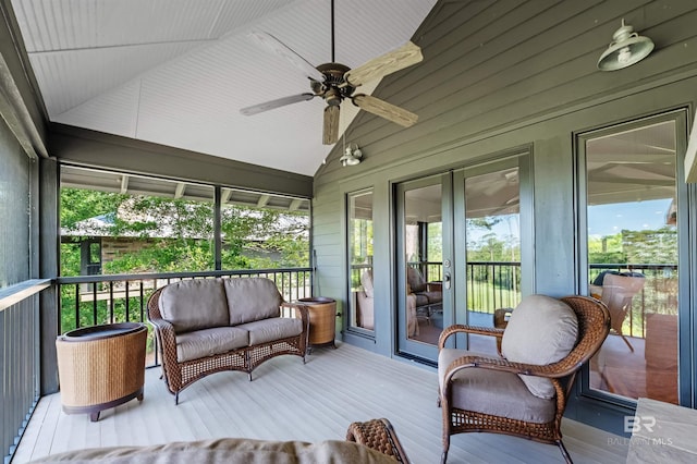 sunroom with ceiling fan, vaulted ceiling, and an outdoor hangout area