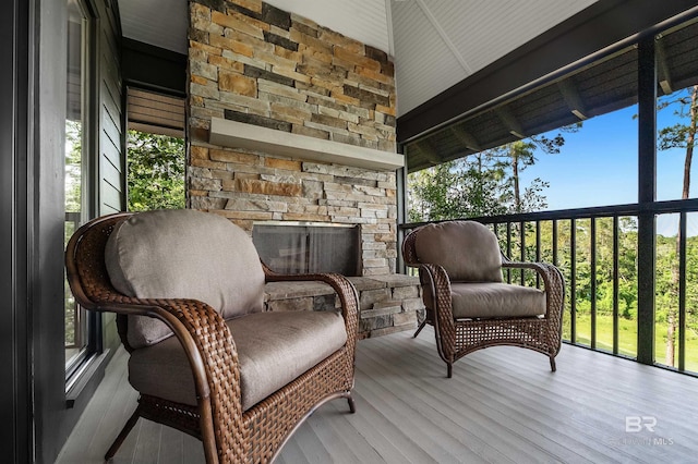 wooden deck featuring a stone fireplace