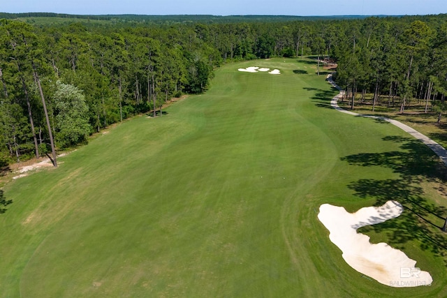 drone / aerial view of a heavily wooded area and a local golf course