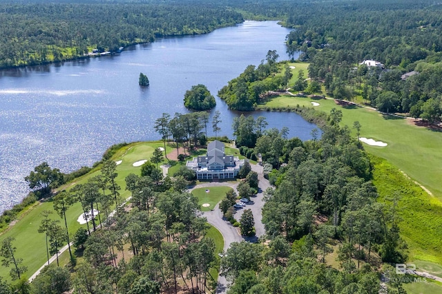 aerial overview of property's location with a nearby body of water, a heavily wooded area, and a golf course