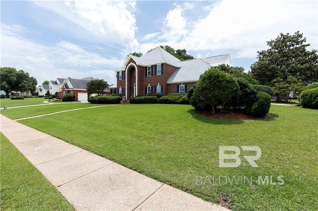 1140 E Dominion Dr, Mobile, AL 36695 - colonial home featuring a front yard and a garage