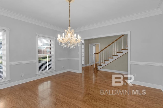 1140 E Dominion Dr, Mobile, AL 36695 - unfurnished dining area featuring a chandelier, wood finished floors, ornamental molding, and stairway
