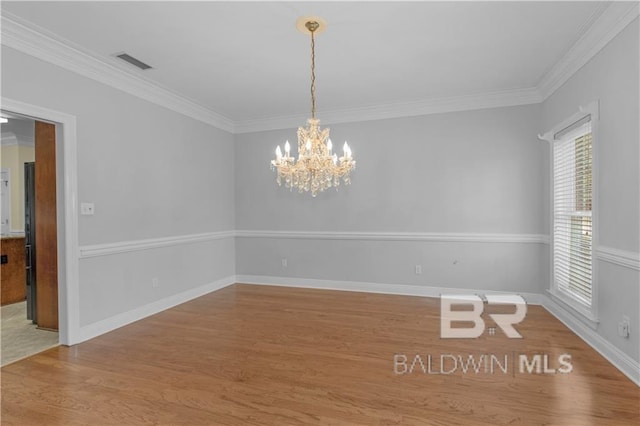 1140 E Dominion Dr, Mobile, AL 36695 - unfurnished room featuring wood finished floors, a chandelier, and ornamental molding