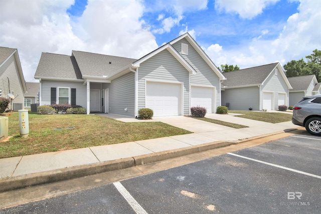 ranch-style house featuring a front lawn and a garage