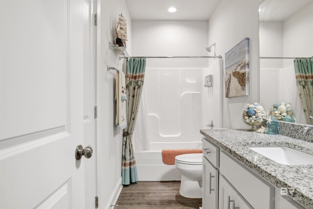 bathroom with recessed lighting, toilet, shower / bath combination with curtain, vanity, and wood finished floors