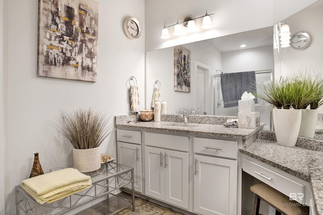 bathroom featuring vanity and recessed lighting