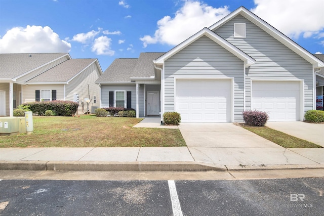 view of front of property featuring a garage, a front lawn, and driveway