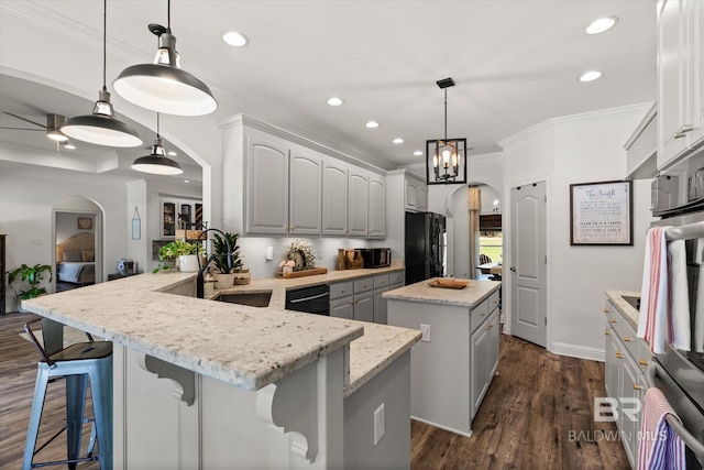 14281 Timber Ridge Dr, Loxley, AL 36551 - kitchen with black appliances, a kitchen island, recessed lighting, a peninsula, and arched walkways