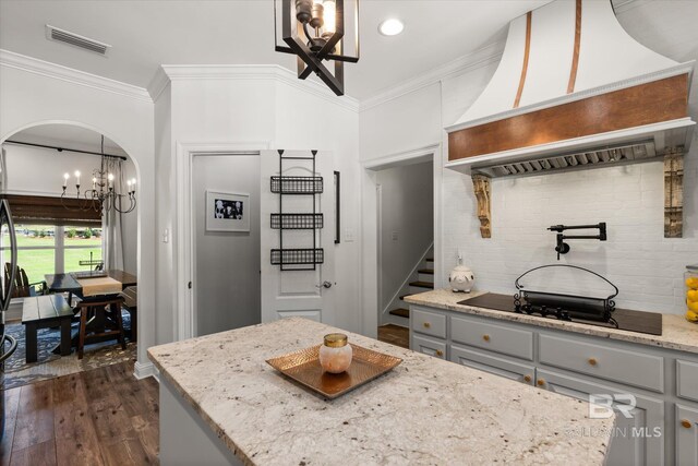 14281 Timber Ridge Dr, Loxley, AL 36551 - kitchen featuring a chandelier, gray cabinets, black electric stovetop, custom exhaust hood, and crown molding