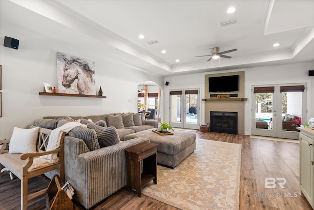 14281 Timber Ridge Dr, Loxley, AL 36551 - living area with a tray ceiling, hardwood / wood-style floors, arched walkways, recessed lighting, and a ceiling fan