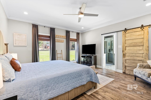 14281 Timber Ridge Dr, Loxley, AL 36551 - bedroom with a barn door, recessed lighting, wood finished floors, crown molding, and ensuite bathroom