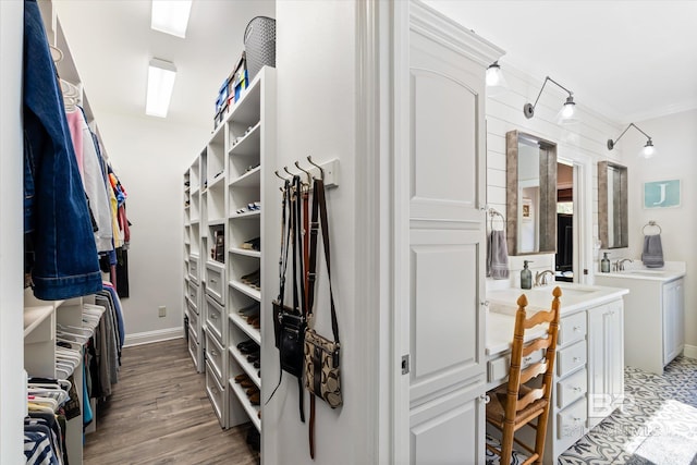14281 Timber Ridge Dr, Loxley, AL 36551 - walk in closet featuring a sink and wood finished floors