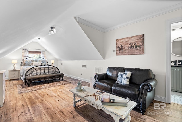 14281 Timber Ridge Dr, Loxley, AL 36551 - bedroom featuring wood-type flooring, lofted ceiling, and ensuite bath