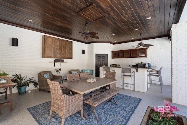 14281 Timber Ridge Dr, Loxley, AL 36551 - dining area with ceiling fan, speckle patterned floor, brick wall, wooden ceiling, and recessed lighting