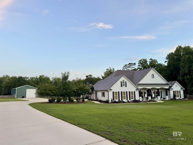 14281 Timber Ridge Dr, Loxley, AL 36551 - view of front of home featuring a detached garage, an outdoor structure, a porch, a front lawn, and driveway