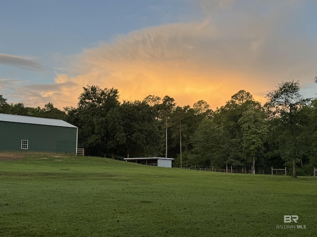 14281 Timber Ridge Dr, Loxley, AL 36551 - yard at dusk with a pole building, a yard, and an outbuilding