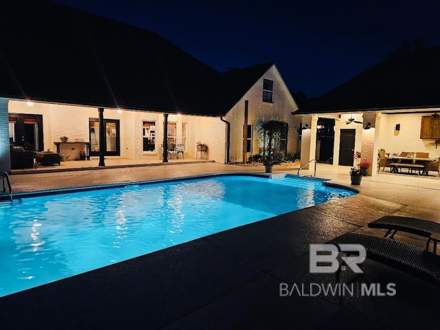 14281 Timber Ridge Dr, Loxley, AL 36551 - pool at night with an outdoor pool and a patio