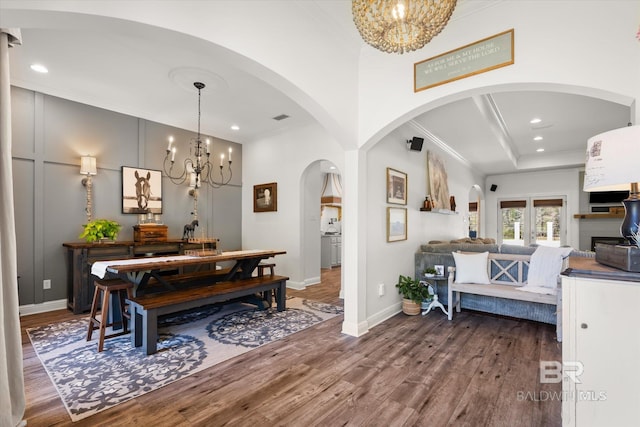 14281 Timber Ridge Dr, Loxley, AL 36551 - dining area with a chandelier, dark wood-style flooring, crown molding, recessed lighting, and arched walkways