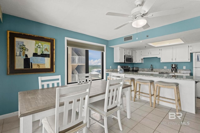 24132 Perdido Beach Blvd Unit 1081, Orange Beach, AL 36561 - dining room with a ceiling fan and light tile patterned floors