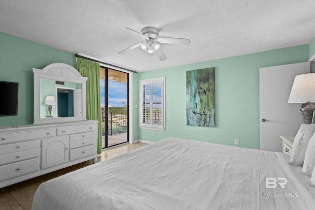 24132 Perdido Beach Blvd Unit 1081, Orange Beach, AL 36561 - tiled bedroom featuring access to exterior, a ceiling fan, and a wall of windows