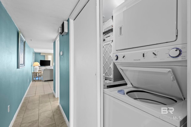 24132 Perdido Beach Blvd Unit 1081, Orange Beach, AL 36561 - washroom featuring stacked washer / dryer and light tile patterned floors
