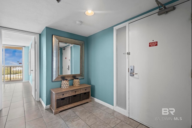 24132 Perdido Beach Blvd Unit 1081, Orange Beach, AL 36561 - hallway with light tile patterned floors and floor to ceiling windows