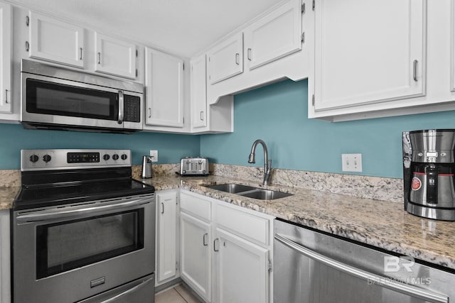 24132 Perdido Beach Blvd Unit 1081, Orange Beach, AL 36561 - kitchen featuring stainless steel appliances, white cabinets, and light stone counters