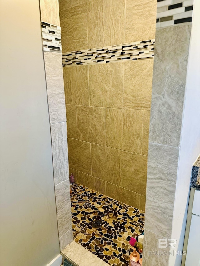 bathroom with tiled shower