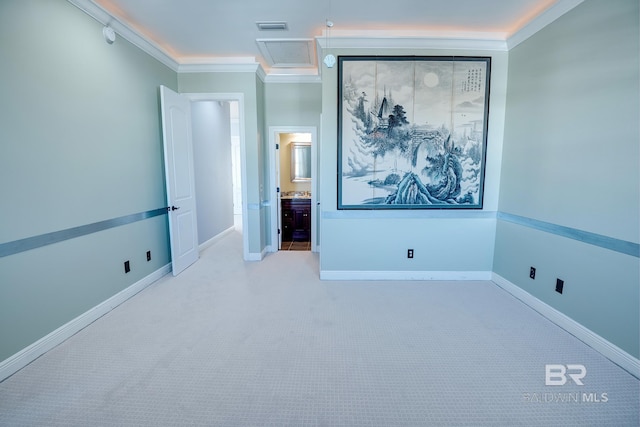 unfurnished bedroom with light colored carpet, ensuite bath, and crown molding