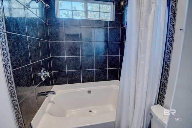 bathroom with shower / bath combination with curtain and toilet