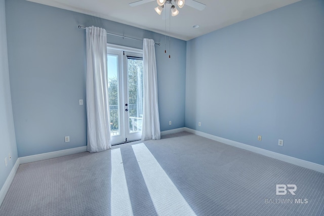 carpeted spare room featuring french doors and ceiling fan