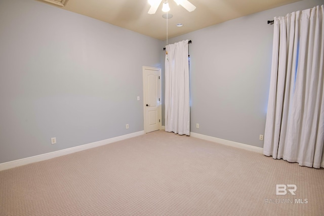 carpeted spare room with ceiling fan