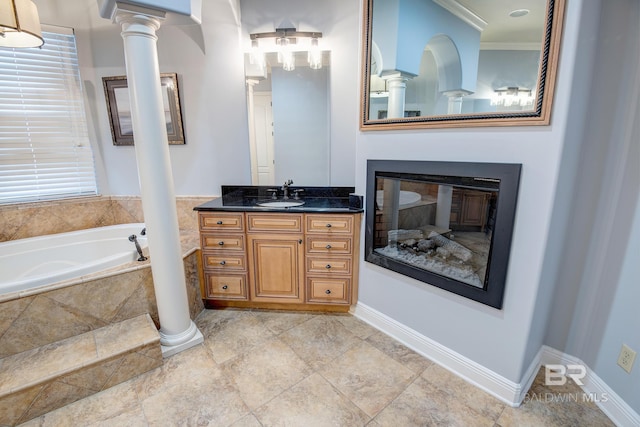 bathroom featuring vanity, ornamental molding, and tiled bath