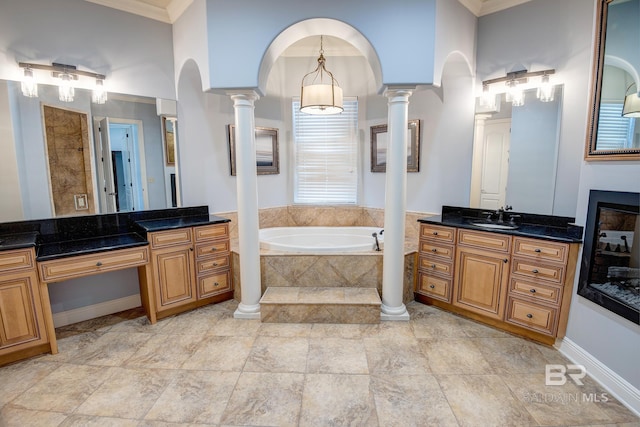 bathroom featuring vanity, tiled bath, and ornamental molding