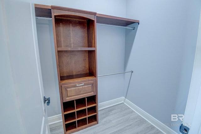 spacious closet with light hardwood / wood-style floors