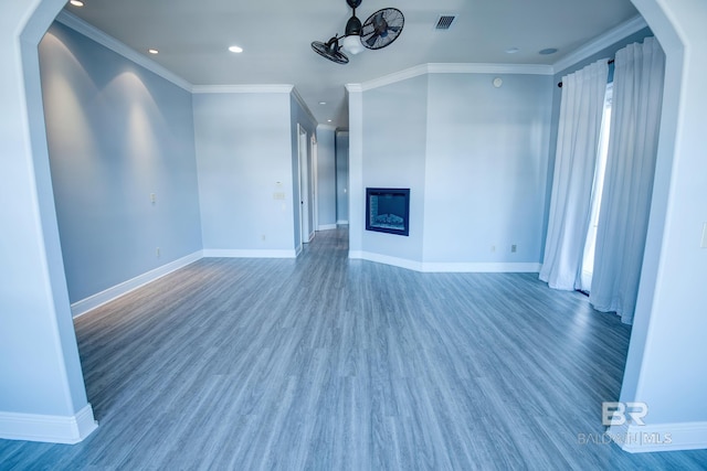 unfurnished living room featuring crown molding and dark hardwood / wood-style floors