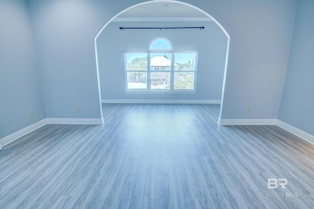 interior space featuring light wood-type flooring and crown molding