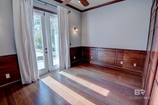 doorway to outside featuring dark hardwood / wood-style floors, ornamental molding, and a wealth of natural light