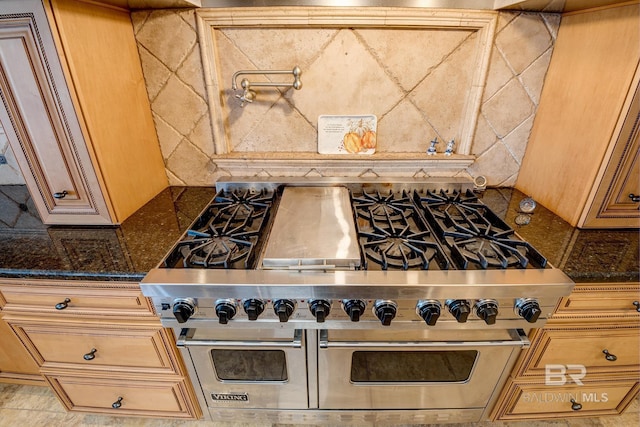 kitchen featuring dark stone counters and double oven range