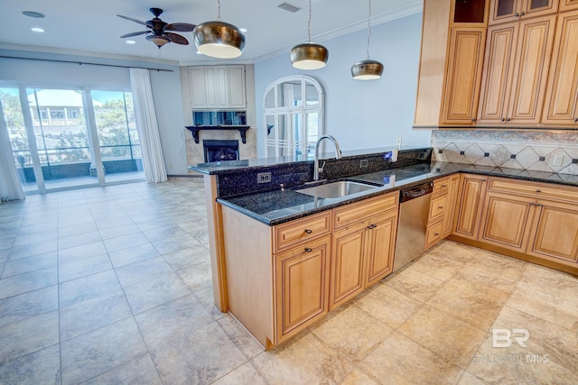 kitchen featuring sink, hanging light fixtures, tasteful backsplash, stainless steel dishwasher, and dark stone counters