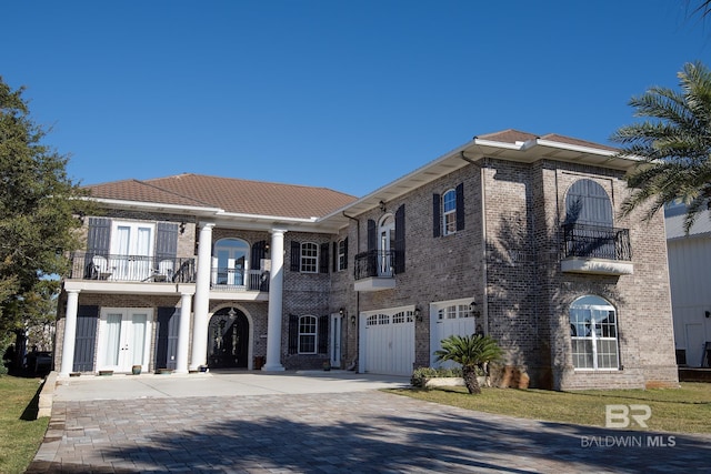 view of front facade with a balcony and a garage