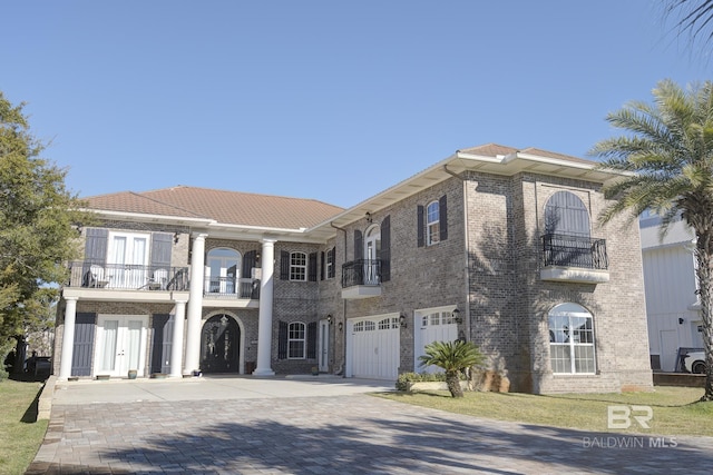 view of front facade featuring a balcony and a garage