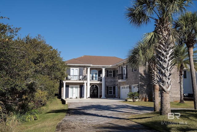 view of front of property with a balcony and a garage