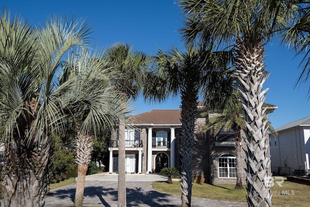 view of front of property featuring a garage and a balcony