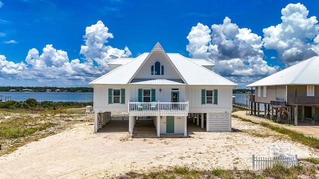 2764 W Beach Blvd, Gulf Shores, AL 36542 - view of front of property featuring driveway, a water view, a metal roof, and a carport