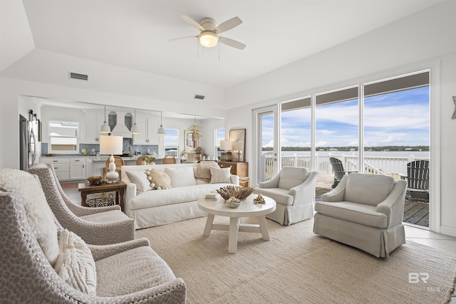 2764 W Beach Blvd, Gulf Shores, AL 36542 - living room with a ceiling fan, a water view, and light tile patterned floors