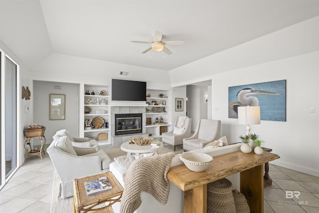 2764 W Beach Blvd, Gulf Shores, AL 36542 - living room with light tile patterned flooring, ceiling fan, a fireplace, and built in features