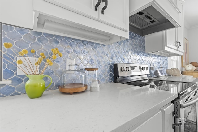 2764 W Beach Blvd, Gulf Shores, AL 36542 - kitchen with stainless steel electric range oven, ventilation hood, tasteful backsplash, white cabinetry, and light stone counters