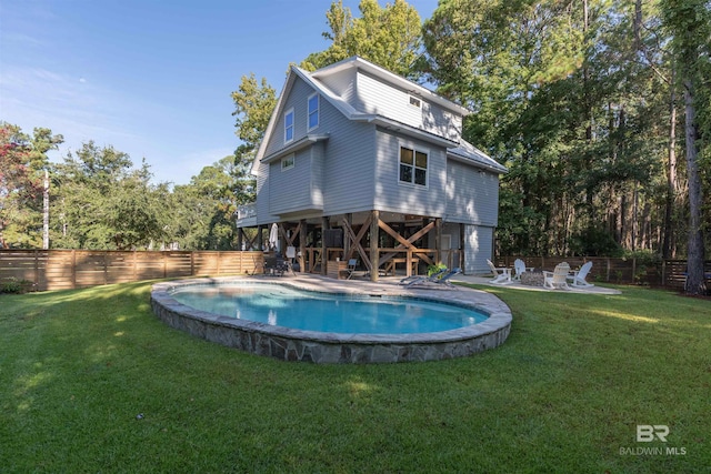 view of swimming pool featuring a yard, a patio, a fenced backyard, and a fenced in pool