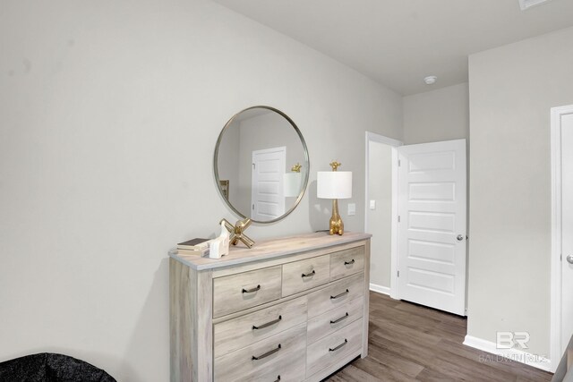 bedroom with dark hardwood / wood-style flooring